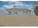 Exterior shot of home highlighting the backyard and patio area, perfect for entertaining at 131 Meadowbrook Ln, Grantville, GA 30220