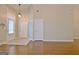 Spacious living room with hardwood floors, neutral paint, and a view of the front entry at 131 Meadowbrook Ln, Grantville, GA 30220