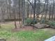 Backyard showcasing trees, wooden deck, and lush greenery for a serene outdoor space at 57 Kristina Ct, Acworth, GA 30101