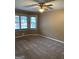 A bedroom with carpeted floors, a ceiling fan, and lots of natural light at 57 Kristina Ct, Acworth, GA 30101