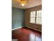 Inviting bedroom with hardwood floors, natural light, and a calming blue accent wall at 57 Kristina Ct, Acworth, GA 30101