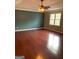 Spacious bedroom with hardwood floors, natural light, and calming green accent wall at 57 Kristina Ct, Acworth, GA 30101