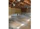 Spacious unfinished garage with overhead storage, exposed rafters, and concrete floor offering potential at 57 Kristina Ct, Acworth, GA 30101