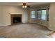 Living room featuring a brick fireplace, a ceiling fan, carpeted floors and lots of light at 57 Kristina Ct, Acworth, GA 30101