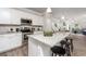 Modern kitchen with stainless steel appliances, granite countertops, and an island with bar seating at 1492 Trellis Court (Lot 44), Hampton, GA 30228