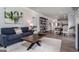 Open-concept living space with modern furniture, a statement coffee table, and views into the kitchen and dining area at 1492 Trellis Court (Lot 44), Hampton, GA 30228