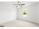 Spacious carpeted bedroom with ceiling fan and natural light from window at 153 Cedar Ridge Rd, Locust Grove, GA 30248