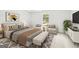 Serene bedroom featuring a tray ceiling, sitting area, and a cozy queen-sized bed at 153 Cedar Ridge Rd, Locust Grove, GA 30248