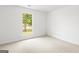 An empty bedroom provides a blank canvas with a window view to the outdoors at 153 Cedar Ridge Rd, Locust Grove, GA 30248