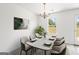 Elegant dining room featuring a modern chandelier, a window view, and seating for eight at 153 Cedar Ridge Rd, Locust Grove, GA 30248