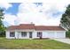 Charming single-story home with a well-manicured lawn, red shutters, and a covered front porch at 153 Cedar Ridge Rd, Locust Grove, GA 30248