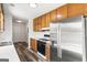 Functional kitchen with stainless steel appliances, white countertops, and wood-finished cabinets at 153 Cedar Ridge Rd, Locust Grove, GA 30248