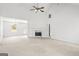Spacious, open-concept living room with a fireplace, neutral tones, and ample natural light at 153 Cedar Ridge Rd, Locust Grove, GA 30248