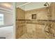 Tiled shower with mosaic trim, featuring adjustable shower head, convenient grab bars, and a built-in niche at 153 Cedar Ridge Rd, Locust Grove, GA 30248