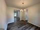 Dining room featuring hardwood floors, neutral walls, chandelier, and easy access to the kitchen at 1825 Harmony Trce # 6, Lithonia, GA 30058