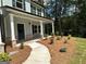 Landscaped front yard with mulch beds, a walkway to the front door, and lush greenery at 1825 Harmony Trce # 6, Lithonia, GA 30058