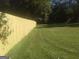 Large grassy backyard with a brand new wooden fence, perfect for entertaining or enjoying outdoor activities at 2421 Rockbridge Sw Rd, Stone Mountain, GA 30087