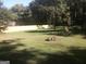 Backyard featuring a well-maintained lawn, sturdy fence and surrounding trees at 2421 Rockbridge Sw Rd, Stone Mountain, GA 30087