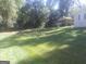 Very Large backyard featuring open lawn and a detached carport structure at 2421 Rockbridge Sw Rd, Stone Mountain, GA 30087