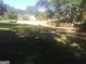 Large backyard with a newly built, light-colored wooden fence surrounding the property at 2421 Rockbridge Sw Rd, Stone Mountain, GA 30087