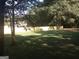 Backyard featuring mature trees, a grassy lawn, and a secure wooden fence around the property at 2421 Rockbridge Sw Rd, Stone Mountain, GA 30087
