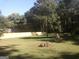 Spacious backyard with a green lawn, framed by trees and a secure wooden fence at 2421 Rockbridge Sw Rd, Stone Mountain, GA 30087