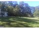 Expansive lush backyard with mature trees, offering a peaceful retreat at 2421 Rockbridge Sw Rd, Stone Mountain, GA 30087