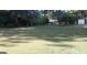 Expansive backyard with a manicured lawn and landscaped surroundings at 2421 Rockbridge Sw Rd, Stone Mountain, GA 30087