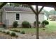 View of a backyard with mature trees and landscaping from a covered area, adding to the outdoor appeal at 2421 Rockbridge Sw Rd, Stone Mountain, GA 30087