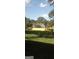 Fenced backyard with a spacious lawn, bordered by mature trees and a clear blue sky at 2421 Rockbridge Sw Rd, Stone Mountain, GA 30087