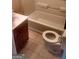 A simple bathroom features a tub, tile flooring, and a vanity at 2421 Rockbridge Sw Rd, Stone Mountain, GA 30087