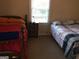 Bedroom with two beds, a center table, and a bright window at 2421 Rockbridge Sw Rd, Stone Mountain, GA 30087