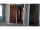Carpeted bedroom with closet, two doors, and natural light at 2421 Rockbridge Sw Rd, Stone Mountain, GA 30087