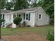 Exterior view of home with a covered porch and well-maintained landscaping, showcasing its curb appeal at 2421 Rockbridge Sw Rd, Stone Mountain, GA 30087
