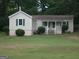 Inviting single-story home featuring a classic design with a covered front porch and green lawn at 2421 Rockbridge Sw Rd, Stone Mountain, GA 30087
