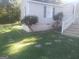 Landscaped front yard with mature bushes, steps to enter the property and rock details at 2421 Rockbridge Sw Rd, Stone Mountain, GA 30087