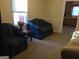 Cozy living room with comfortable seating and connecting to kitchen at 2421 Rockbridge Sw Rd, Stone Mountain, GA 30087