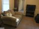 Comfortable living room with neutral walls, a sofa, and a television at 2421 Rockbridge Sw Rd, Stone Mountain, GA 30087