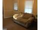 Living room features a sofa and neutral colored carpet at 2421 Rockbridge Sw Rd, Stone Mountain, GA 30087