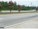 A view of a road with landscaping and trees along the sides at 2421 Rockbridge Sw Rd, Stone Mountain, GA 30087