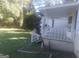 Well-manicured front yard with charming landscaping and a cozy porch at 2421 Rockbridge Sw Rd, Stone Mountain, GA 30087