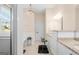 Bright bathroom with a black and white patterned floor, dual vanities and a separate tub area at 101 Kenmare Row, Tyrone, GA 30290