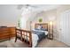 A bedroom featuring a wooden bed frame, ceiling fan, and natural light at 101 Kenmare Row, Tyrone, GA 30290