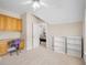 Bedroom with a built-in desk, chair, three white bookcases, and view to another bedroom at 101 Kenmare Row, Tyrone, GA 30290