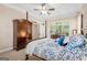 Spacious bedroom with a four-poster bed, armoire, and natural light at 101 Kenmare Row, Tyrone, GA 30290