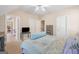 Bedroom with a large bed, neutral carpet, and a glimpse into an office space at 101 Kenmare Row, Tyrone, GA 30290