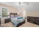 Bedroom with a modern bed frame, wooden dresser, and a ceiling fan at 101 Kenmare Row, Tyrone, GA 30290