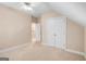 Neutral bedroom featuring a carpeted floor, two large closets, and a ceiling fan at 101 Kenmare Row, Tyrone, GA 30290