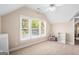 Bright room with a carpet, large window with blinds and neutral color scheme at 101 Kenmare Row, Tyrone, GA 30290