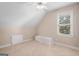 Bedroom with carpet, a window with blinds, a small bench and neutral color scheme at 101 Kenmare Row, Tyrone, GA 30290